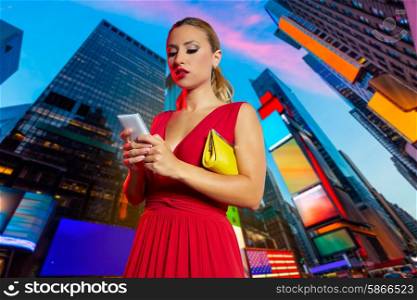 Blond girl red dress smartphone chat writing in Times Square of New York Photomount