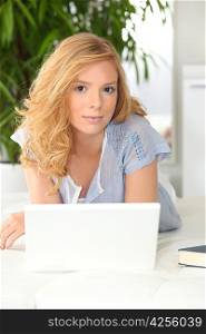 Blond girl using laptop
