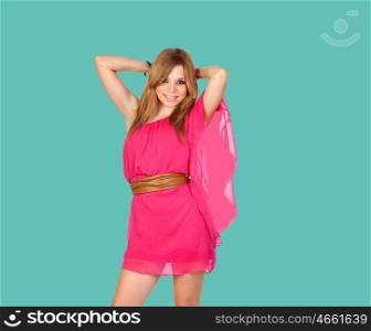 Blond girl with a pink dress on green background
