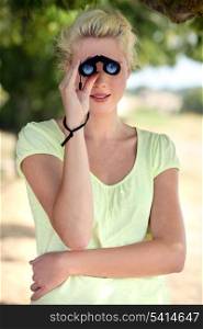 Blond girl with binoculars