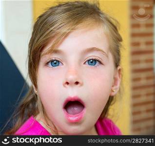 Blond girl with surprised gesture face portrait and open mouth