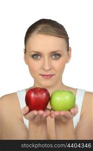 Blond holding green and red apples