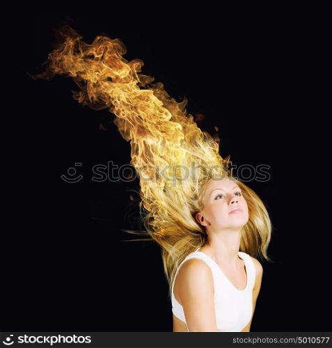 Blond in fire. Young attractive blond woman with hair in fire flames