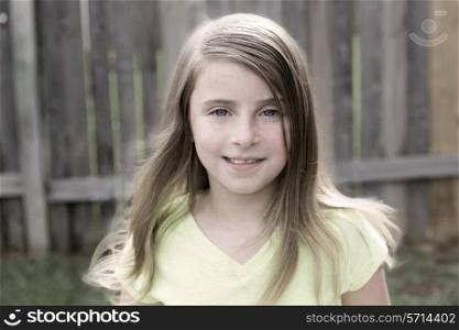 Blond kid girl happy smiling portrait outdoor at backyard