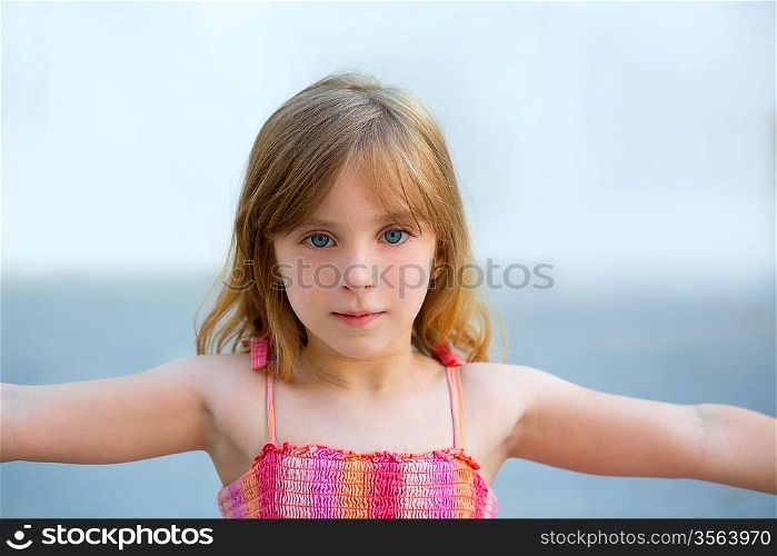 Blond kid girl open arms in outdoor with sundress