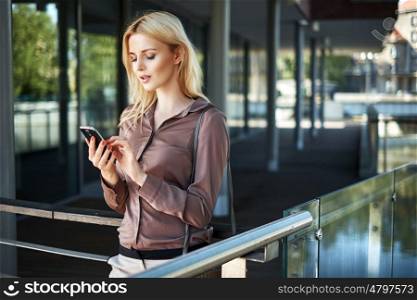 Blond lady using her new generation smartphone