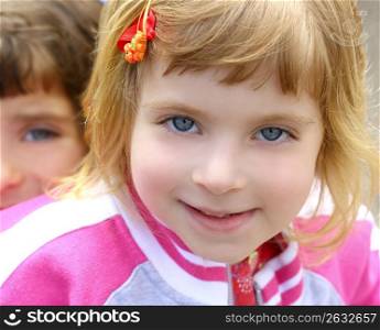 blond little beautiful girl portrait funny gesturing blue eyes face