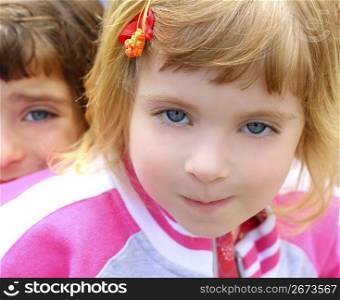 blond little beautiful girl portrait funny gesturing blue eyes face