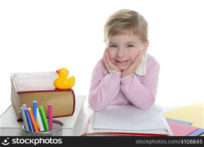 blond little student girl posing and smiling on school desk
