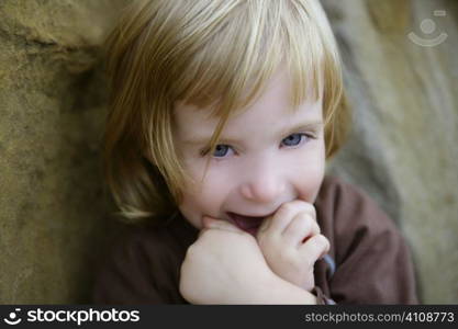Blond little toddler girl with funny gesture portrait