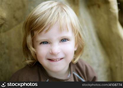 Blond little toddler girl with funny gesture portrait