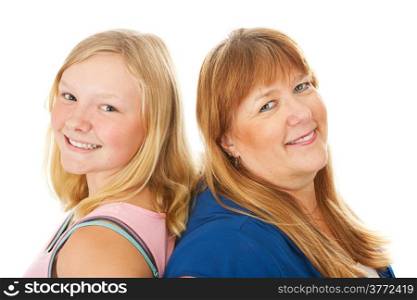 Blond mother and beautiful teenage daughter standing back to back. Isolated on white.