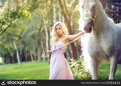 Blond nymph walking with a white horse