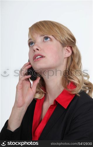 Blond office becoming stressed during telephone call