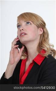 Blond office becoming stressed during telephone call
