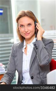 Blond office worker with headphones