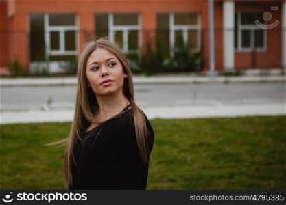 Blond pretty girl with long hair in the street