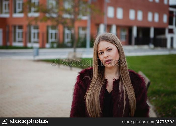 Blond pretty girl with long hair in the street