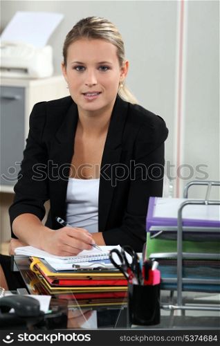 Blond receptionist sat at her desk