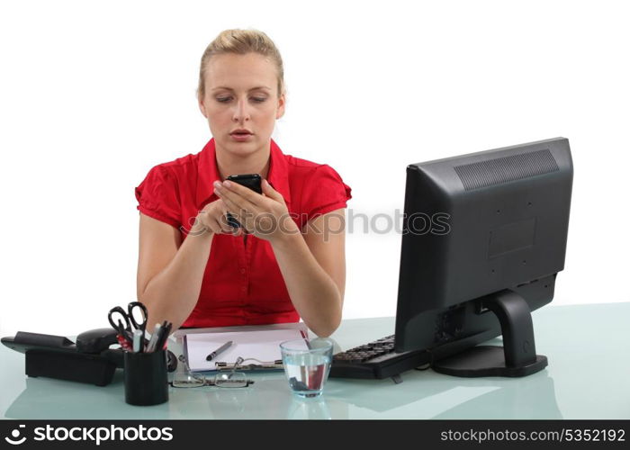 Blond receptionist typing text message