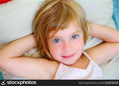 blond relaxed girl on pillow blue eyes smiling looking camera