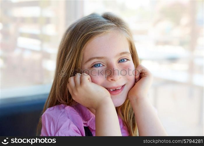 Blond relaxed happy kid girl expression blue eyes smiling
