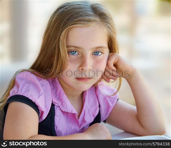 Blond relaxed sad kid girl expression blue eyes portrait