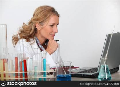 Blond researcher in lab using laptop computer