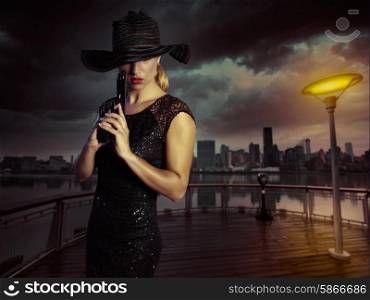 Blond sexy girl with handgun pistol gangster style in New York Photomount