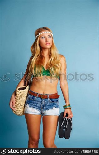 Blond sexy tourist girl with short jeans and basket bag and flip flop shoes going beach