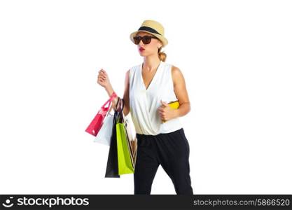 Blond shopaholic woman with bags and smartphone walking gesture