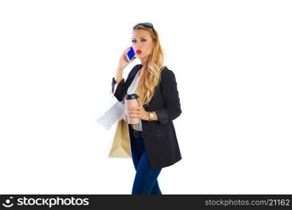 Blond shopaholic woman with bags talking with smartphone on white background