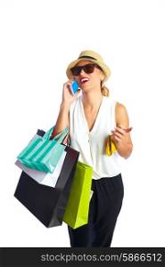 Blond shopaholic woman with bags talking with smartphone on white background