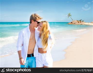 Blond teen couple walking together in the tropical beach at Caribbean sea in Mexico photo mount