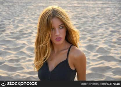Blond teen girl portrait on the summer beach sand