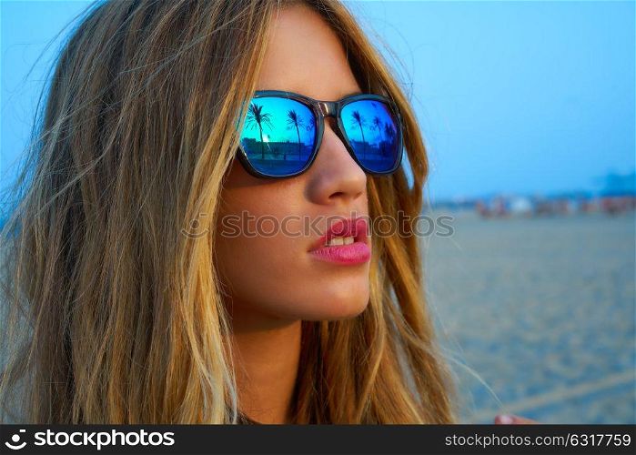 Blond teen girl sunglasses at palm tree summer sunset