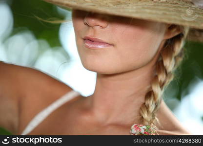 Blond teenage girl wearing hat covering eyes