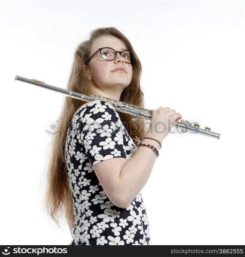 blond teenage girl with glasses holds flute in studio against white background