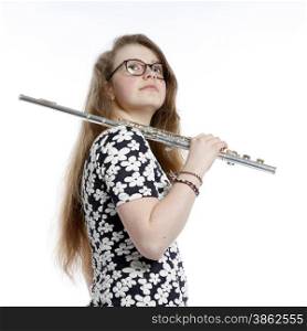 blond teenage girl with glasses holds flute in studio against white background