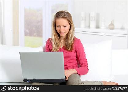 Blond teenager connected on internet at home