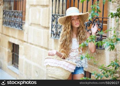 Blond tourist girl in mediterranean old town of Spain