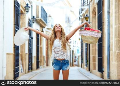 Blond tourist girl in mediterranean old town of Spain