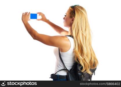 Blond tourist girl taking photos with smartphone on white background