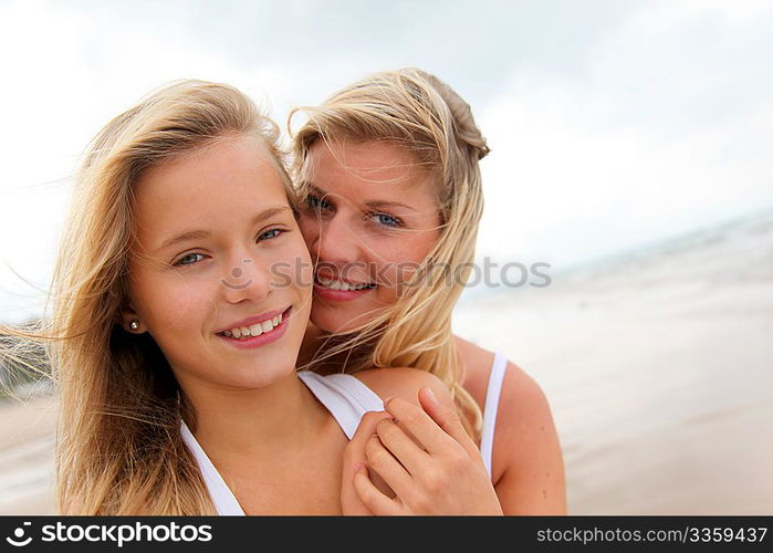 Blond woman and young girl on a sandy beach