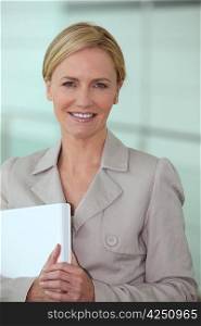 Blond woman carrying computer
