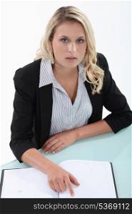 Blond woman checking diary for free appointments