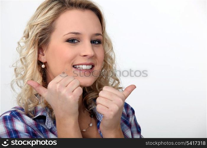 blond woman doing thumbs-up gesture