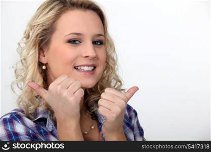 blond woman doing thumbs-up gesture
