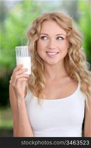 Blond woman drinking fresh milk
