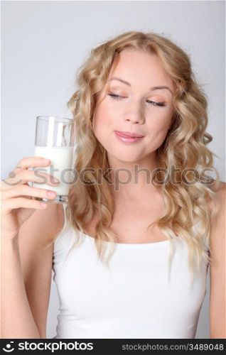 Blond woman drinking fresh milk